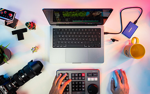 Creative workspace with laptop, camera and design tools